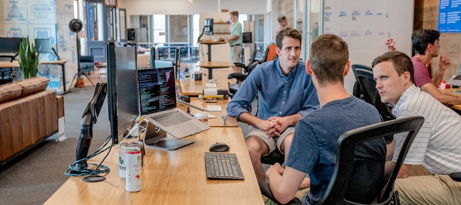 Small business owner creating social media content on a laptop in a modern workspace
